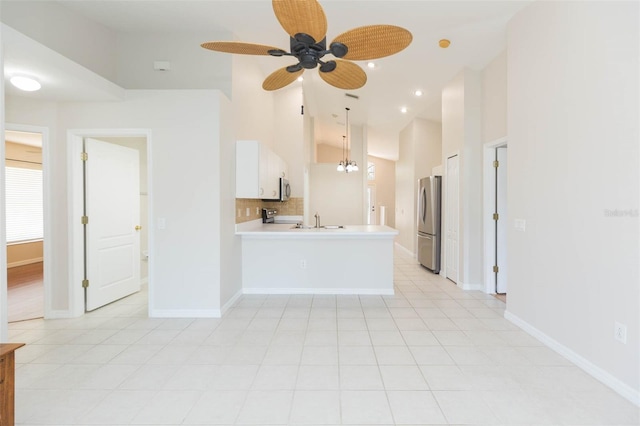 unfurnished living room featuring high vaulted ceiling, baseboards, a ceiling fan, and recessed lighting