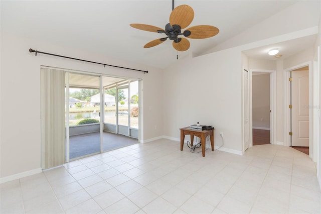 unfurnished room featuring lofted ceiling, baseboards, light tile patterned floors, ceiling fan, and a water view