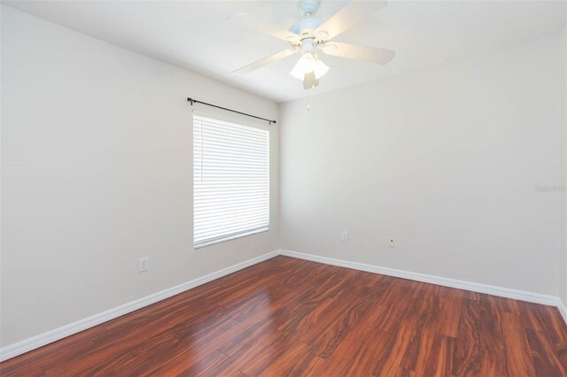 spare room featuring baseboards, a ceiling fan, and wood finished floors