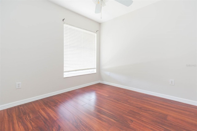 unfurnished room with baseboards, a ceiling fan, and wood finished floors