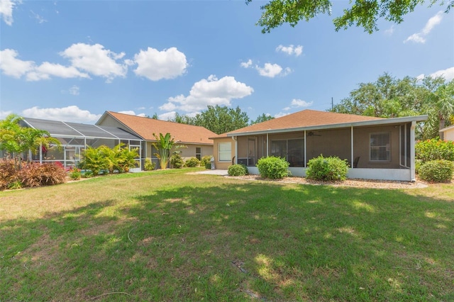back of house featuring a sunroom and a yard