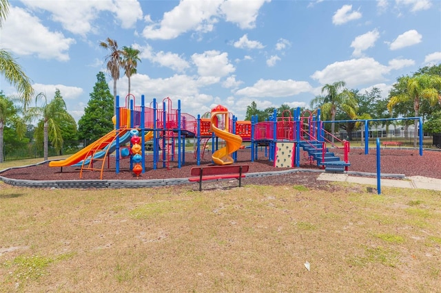 communal playground featuring a lawn