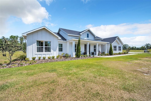 14902 Sweat Loop Rd, Wimauma, FL 33598 - modern farmhouse featuring board and batten siding, a front yard, and covered porch