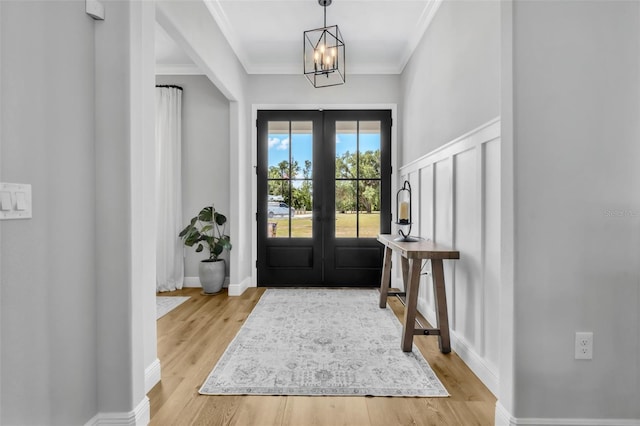 14902 Sweat Loop Rd, Wimauma, FL 33598 - entryway with a chandelier, french doors, light wood finished floors, crown molding, and baseboards