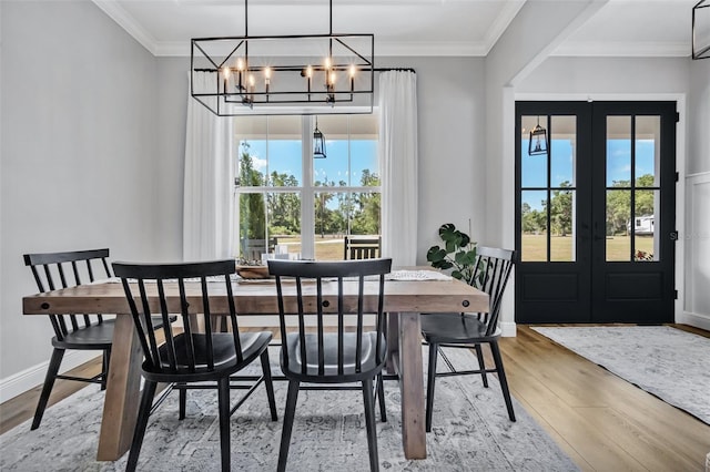 14902 Sweat Loop Rd, Wimauma, FL 33598 - dining room featuring a chandelier, wood finished floors, french doors, ornamental molding, and baseboards