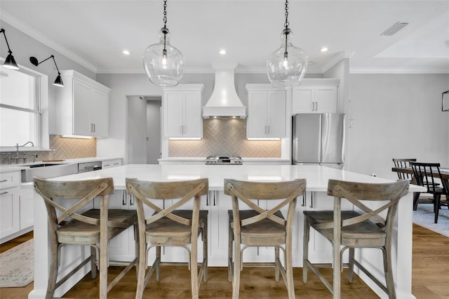 14902 Sweat Loop Rd, Wimauma, FL 33598 - kitchen featuring stainless steel appliances, custom exhaust hood, a center island, decorative backsplash, and recessed lighting