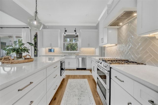 14902 Sweat Loop Rd, Wimauma, FL 33598 - kitchen featuring stainless steel appliances, premium range hood, light countertops, white cabinets, and backsplash