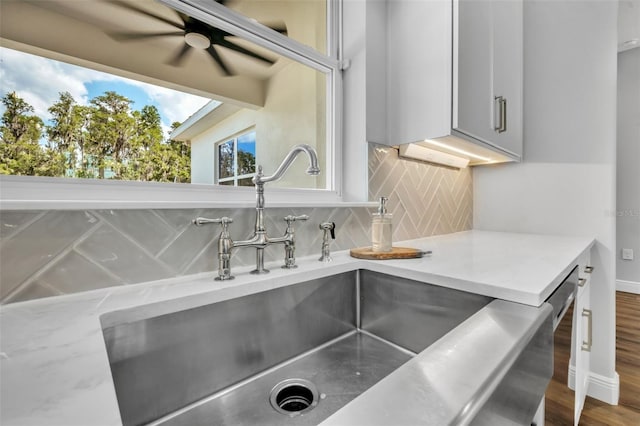 14902 Sweat Loop Rd, Wimauma, FL 33598 - kitchen view of a sink, light countertops, backsplash, and ceiling fan