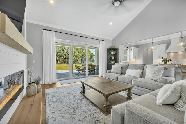 14902 Sweat Loop Rd, Wimauma, FL 33598 - living room featuring a fireplace with raised hearth, high vaulted ceiling, crown molding, a ceiling fan, and recessed lighting