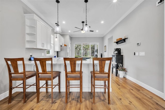 14902 Sweat Loop Rd, Wimauma, FL 33598 - kitchen featuring freestanding refrigerator, white cabinetry, a peninsula, open shelves, and light wood-style flooring