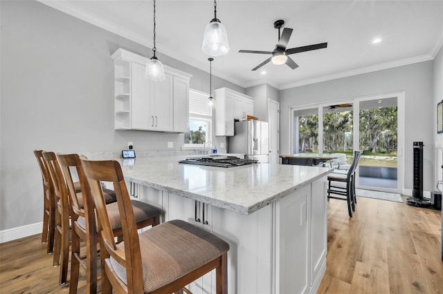 14902 Sweat Loop Rd, Wimauma, FL 33598 - kitchen featuring gas stovetop, a ceiling fan, white cabinetry, white fridge with ice dispenser, and light wood-type flooring