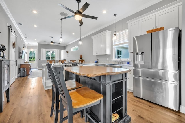 14902 Sweat Loop Rd, Wimauma, FL 33598 - kitchen with stainless steel appliances, a ceiling fan, a sink, crown molding, and light countertops