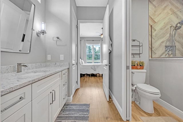 14902 Sweat Loop Rd, Wimauma, FL 33598 - bathroom with ensuite bath, wood finished floors, vanity, ceiling fan, and baseboards
