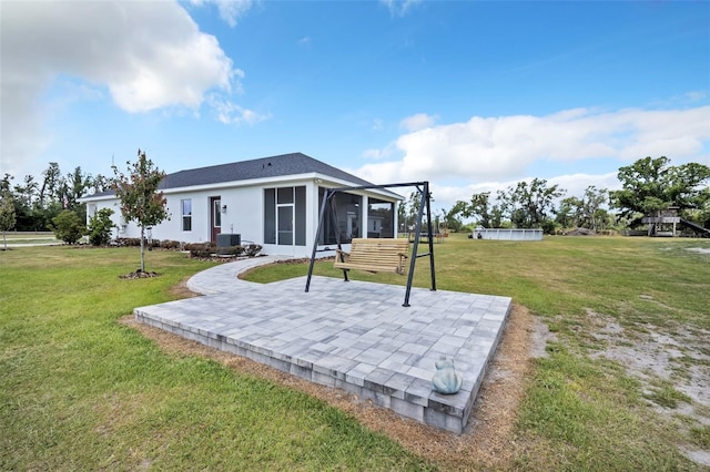 14902 Sweat Loop Rd, Wimauma, FL 33598 - back of property with a sunroom, a patio, a yard, and central air condition unit