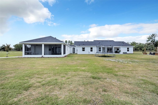 14902 Sweat Loop Rd, Wimauma, FL 33598 - rear view of house featuring a trampoline, a yard, a ceiling fan, and a sunroom