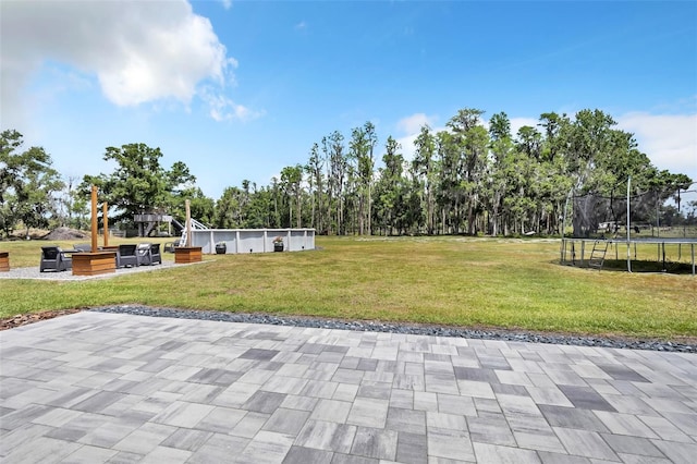 14902 Sweat Loop Rd, Wimauma, FL 33598 - view of community with a trampoline, a patio, and a lawn