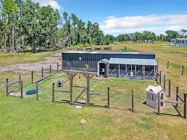 14902 Sweat Loop Rd, Wimauma, FL 33598 - view of grassy yard featuring an outdoor structure, an exterior structure, a gate, and view of scattered trees