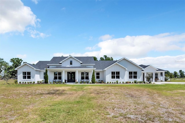 14902 Sweat Loop Rd, Wimauma, FL 33598 - back of property featuring board and batten siding, a yard, and roof with shingles
