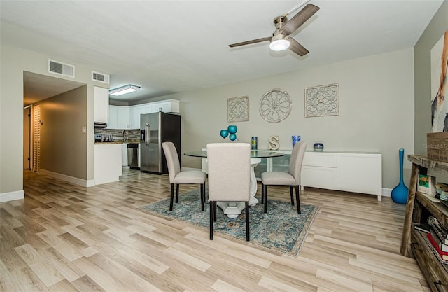 1290 Pine Ridge Cir E Unit G1, Tarpon Springs, FL 34688 - dining area with light wood finished floors, ceiling fan, and baseboards