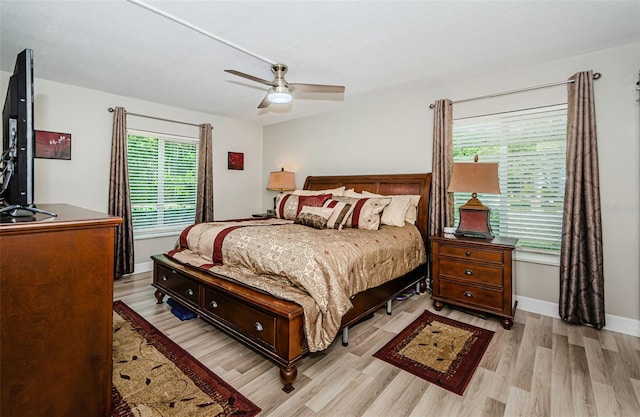 1290 Pine Ridge Cir E Unit G1, Tarpon Springs, FL 34688 - bedroom with light wood finished floors, ceiling fan, and baseboards