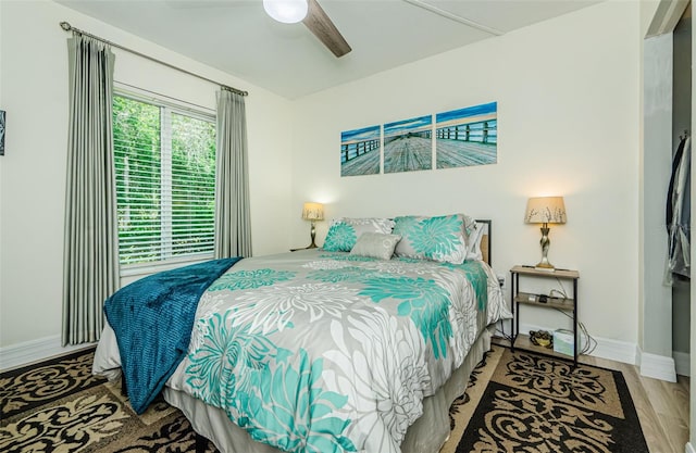 1290 Pine Ridge Cir E Unit G1, Tarpon Springs, FL 34688 - bedroom featuring wood finished floors, baseboards, and ceiling fan