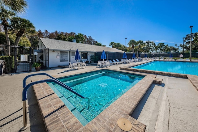 1290 Pine Ridge Cir E Unit G1, Tarpon Springs, FL 34688 - community pool featuring a patio area and fence