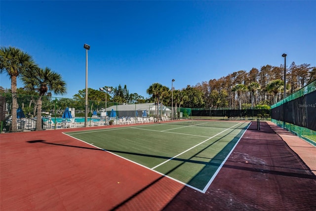 1290 Pine Ridge Cir E Unit G1, Tarpon Springs, FL 34688 - view of tennis court with fence