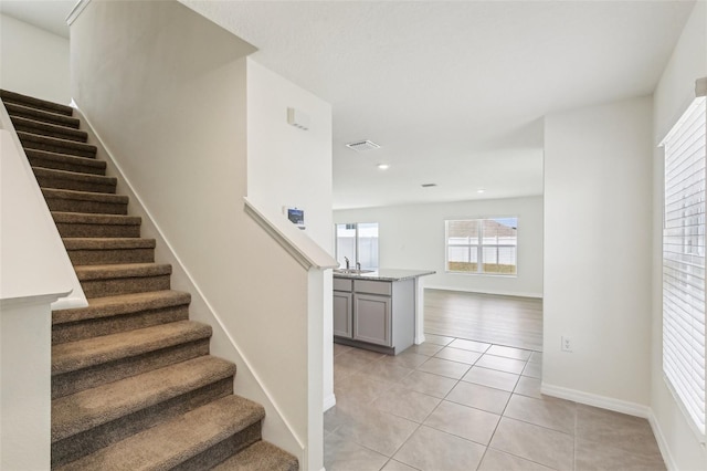 stairway with tile patterned flooring, baseboards, visible vents, and recessed lighting