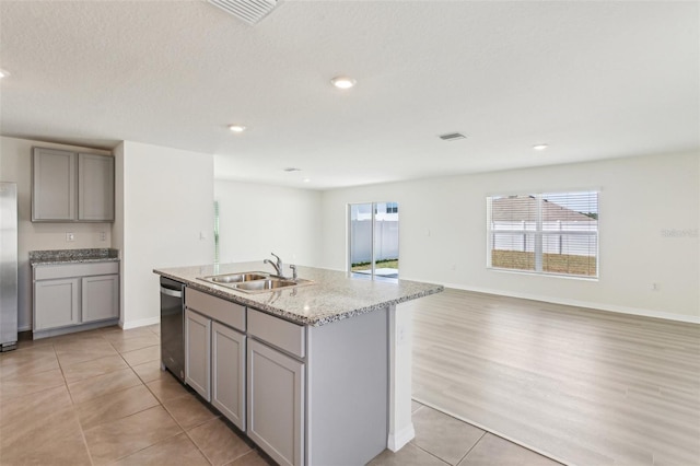 kitchen with gray cabinetry, appliances with stainless steel finishes, plenty of natural light, and a sink
