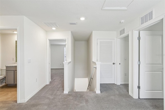 unfurnished bedroom featuring carpet, visible vents, and baseboards