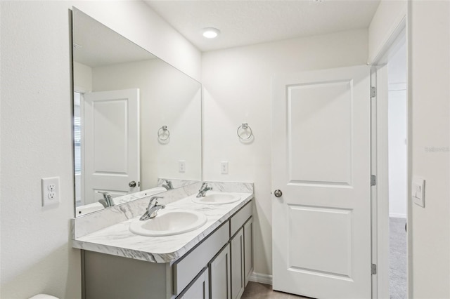 full bathroom featuring double vanity and a sink
