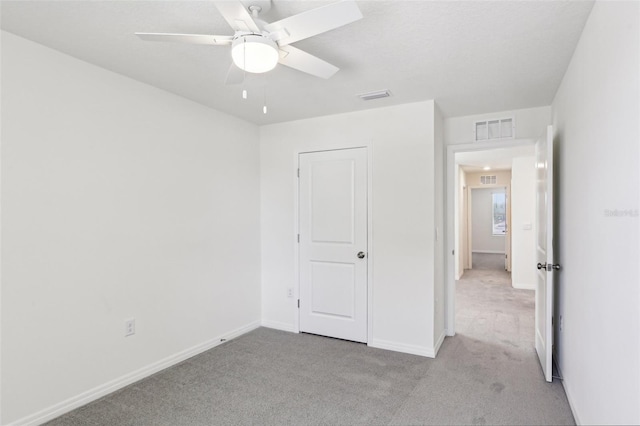 unfurnished bedroom featuring visible vents, baseboards, and carpet floors