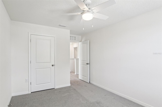 unfurnished bedroom with baseboards, visible vents, and carpet