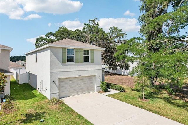 traditional-style home with an attached garage, stucco siding, fence, a front lawn, and driveway