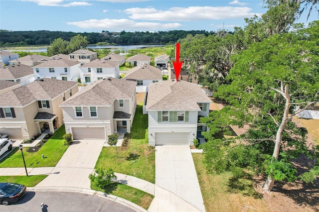 bird's eye view featuring a water view and a residential view