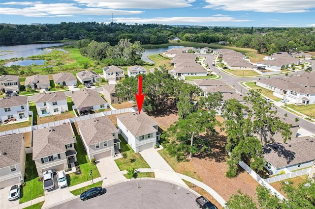 drone / aerial view with a water view and a residential view