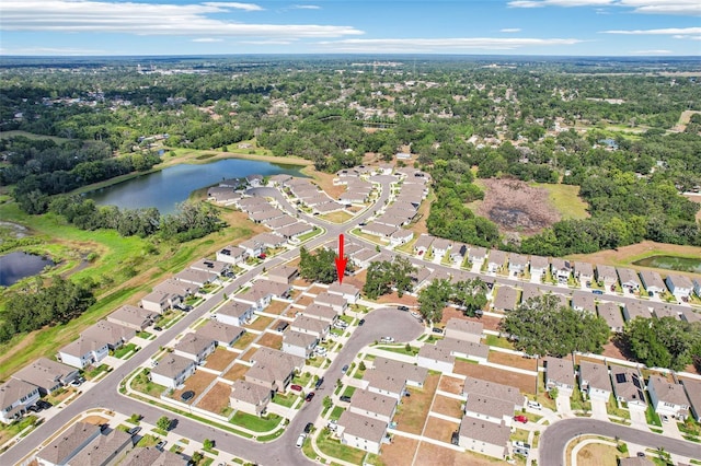 drone / aerial view with a water view and a residential view