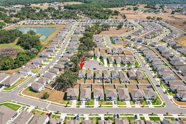 birds eye view of property with a water view and a residential view