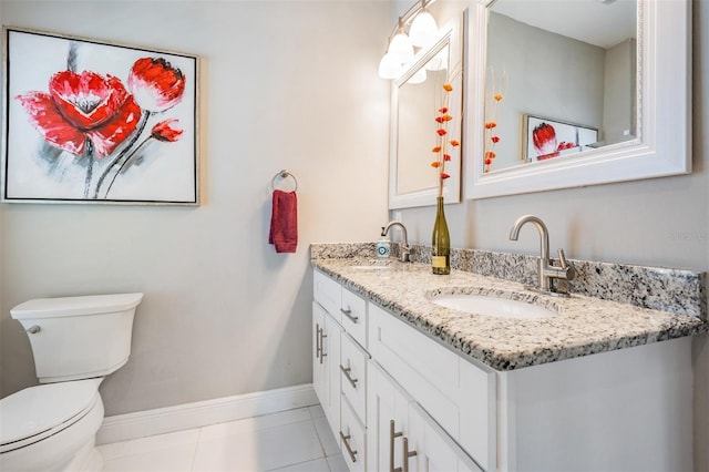 260 SW Lincoln Cir N, Saint Petersburg, FL 33703 - full bathroom with toilet, tile patterned floors, baseboards, and double vanity