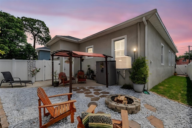 260 SW Lincoln Cir N, Saint Petersburg, FL 33703 - rear view of house featuring an outdoor fire pit, a patio, a gate, stucco siding, and a fenced backyard