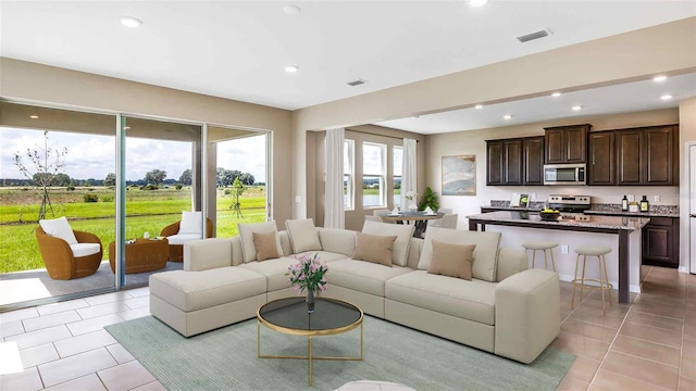 10669 Bridgegate Heights Loop, San Antonio, FL 33576 - living room with light tile patterned floors, visible vents, and recessed lighting