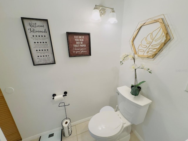 bathroom featuring toilet, baseboards, and tile patterned flooring