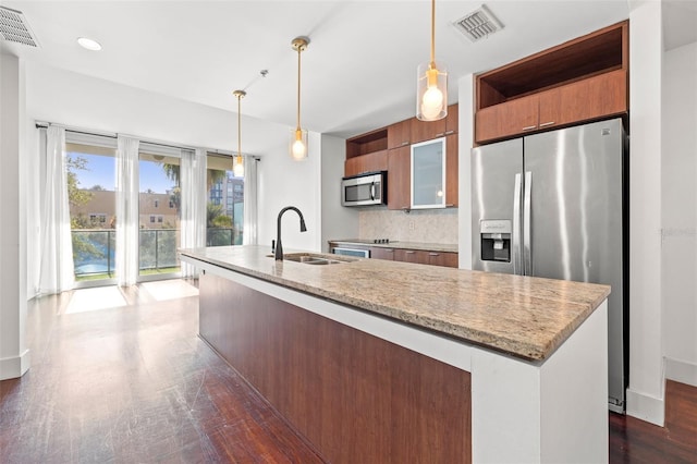 kitchen featuring appliances with stainless steel finishes, a sink, open shelves, a kitchen island with sink, and modern cabinets