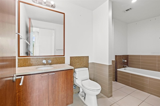 full bathroom with tile patterned flooring, toilet, a bath, and vanity