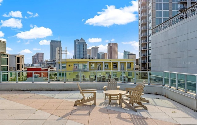 balcony with a skyline view and a patio area