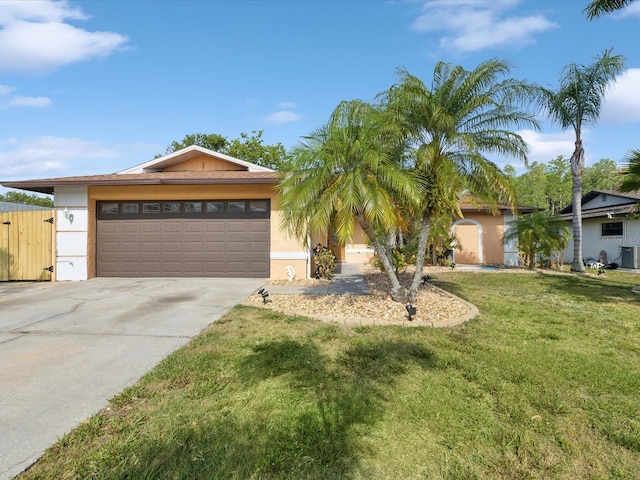 view of front of house featuring central air condition unit, concrete driveway, a garage, stucco siding, and a front lawn