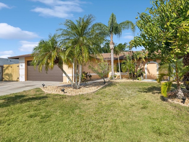 view of front of home with driveway, stucco siding, a front yard, and a garage