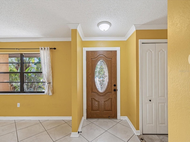 foyer featuring tile patterned floors, a textured ceiling, and crown molding