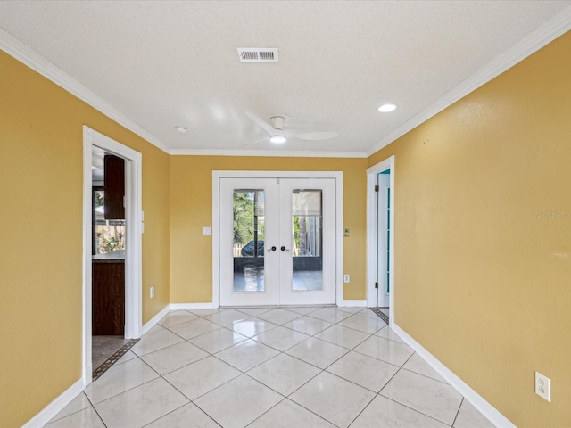 spare room with visible vents, french doors, baseboards, and ornamental molding
