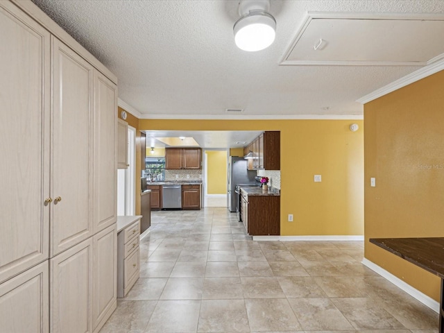 kitchen featuring baseboards, crown molding, decorative backsplash, and dishwasher